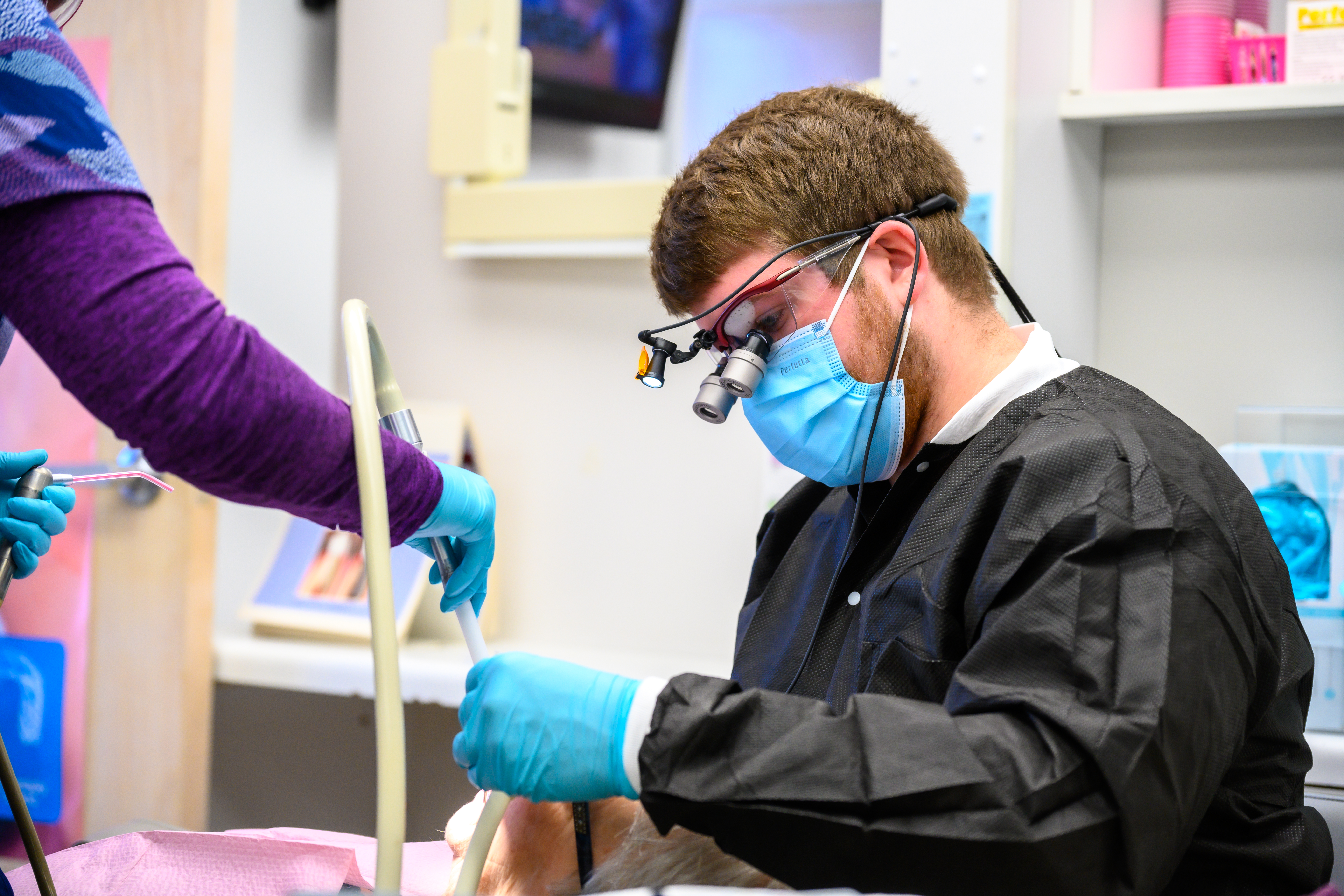 DDS student Zach Lynn treats a patient on his rural rotation at Tebay and Associates in Vienna, WV. 